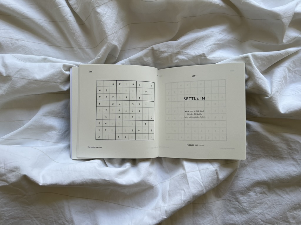 Open Nothing Urgent book showing a puzzle and the Settle In section