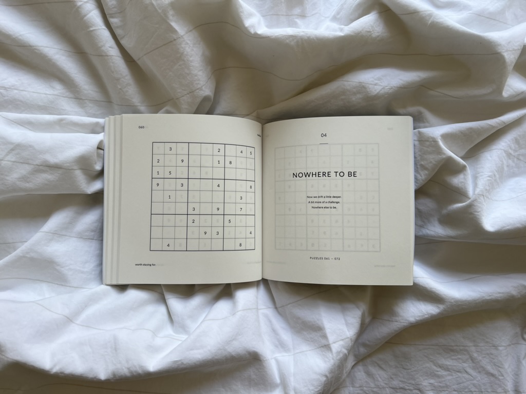Open Nothing Urgent book showing a puzzle and the Nowhere To Be section